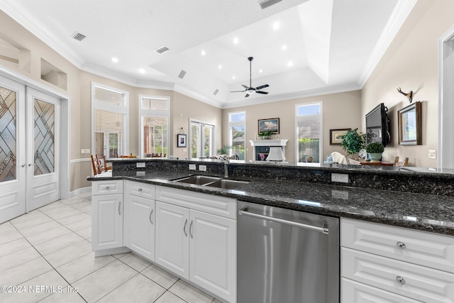 kitchen with dark stone counters, white cabinetry, sink, and dishwasher