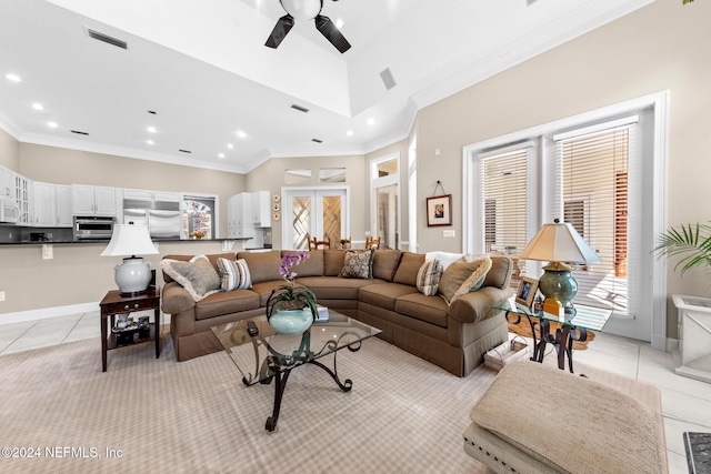 tiled living room with ceiling fan and crown molding