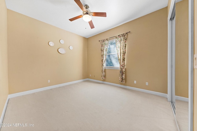 unfurnished room featuring light colored carpet and ceiling fan