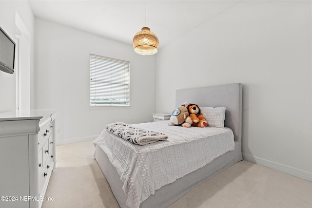 bedroom featuring light colored carpet