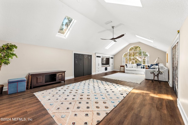 bedroom with dark hardwood / wood-style flooring, ceiling fan, and vaulted ceiling with skylight