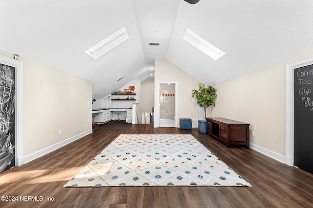 bonus room with dark wood-type flooring and vaulted ceiling with skylight