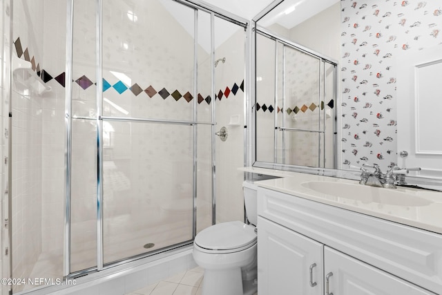 bathroom featuring walk in shower, vanity, toilet, and tile patterned floors