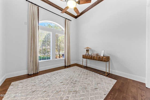 interior space with a wealth of natural light, crown molding, and dark hardwood / wood-style flooring