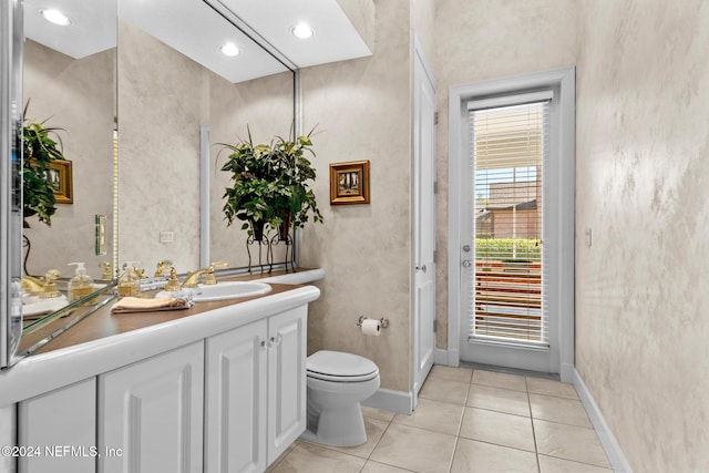 bathroom featuring vanity, tile patterned floors, and toilet