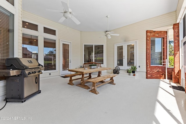 sunroom featuring french doors and ceiling fan