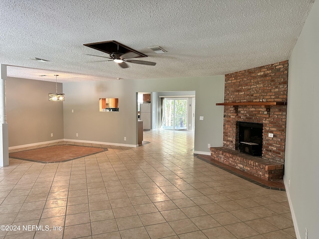 unfurnished living room with visible vents, a brick fireplace, ceiling fan, a textured ceiling, and light tile patterned floors
