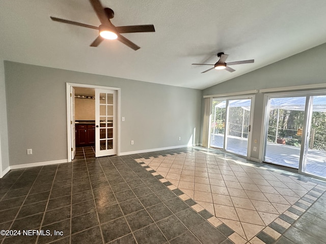 tiled spare room featuring a ceiling fan, baseboards, french doors, and lofted ceiling
