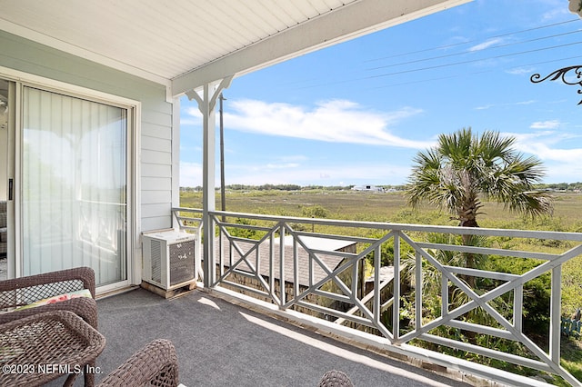 balcony with a rural view and cooling unit