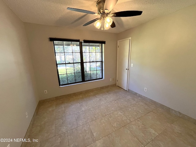 spare room with ceiling fan and a textured ceiling