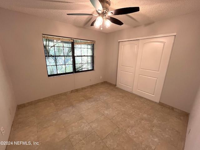 unfurnished bedroom featuring a closet, ceiling fan, and a textured ceiling