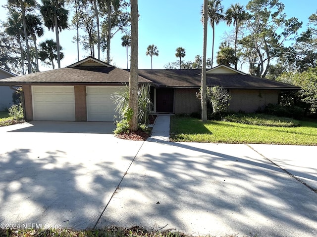 single story home with a front lawn and a garage