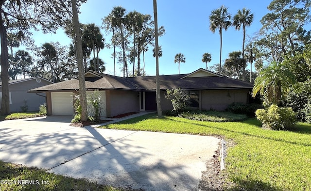 ranch-style home featuring a front lawn and a garage