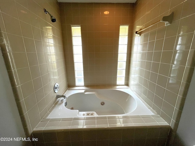 bathroom featuring tiled shower / bath combo and a healthy amount of sunlight