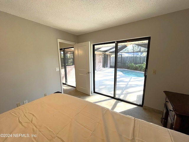 unfurnished bedroom with a textured ceiling and access to outside