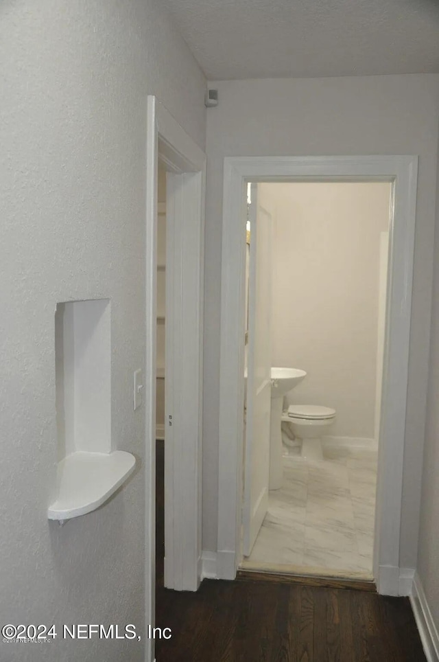 bathroom featuring toilet and hardwood / wood-style floors