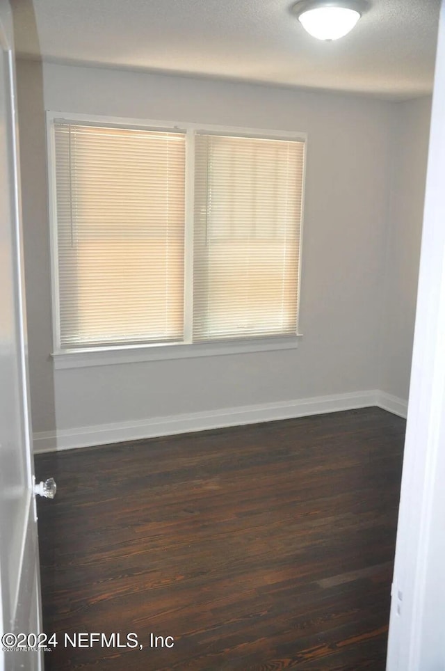 empty room featuring dark hardwood / wood-style floors