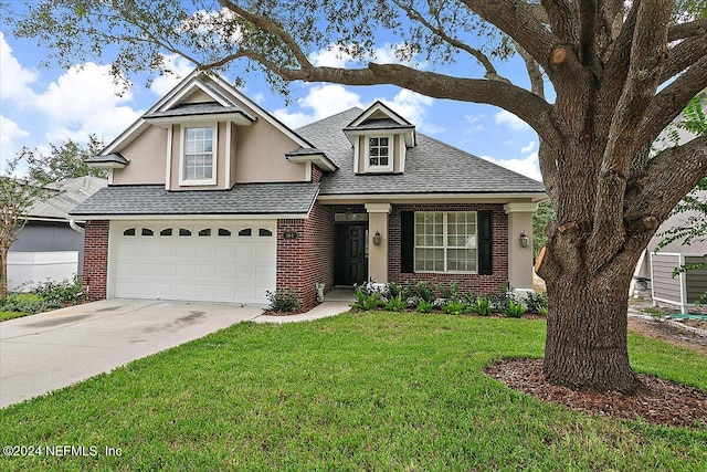 view of property featuring a garage and a front yard