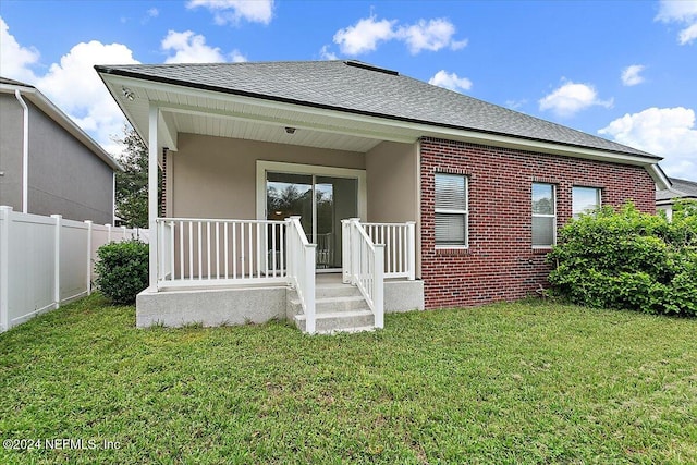 view of front of home featuring covered porch and a front yard