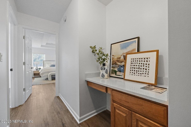 corridor with hardwood / wood-style floors