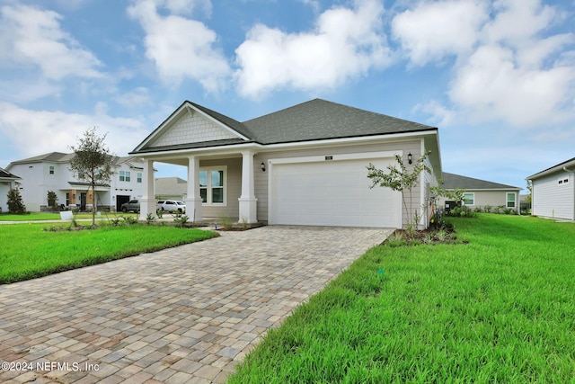 view of front of property featuring a garage and a front yard