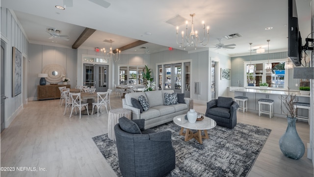 living room with beamed ceiling, french doors, a wealth of natural light, and light hardwood / wood-style flooring