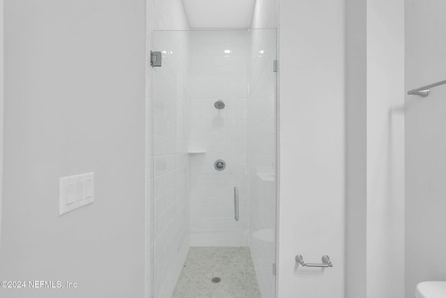 bathroom featuring a shower with door