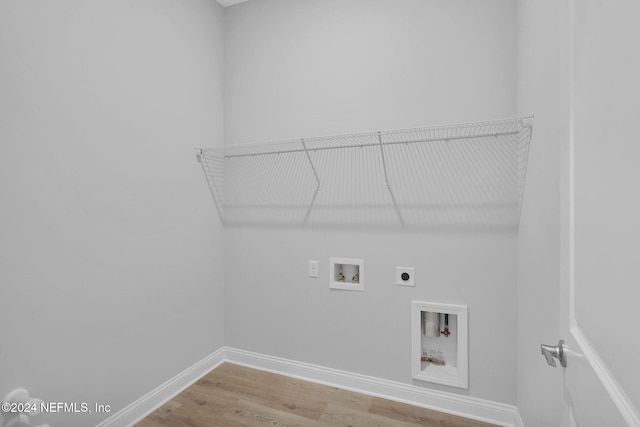 washroom featuring hardwood / wood-style flooring, electric dryer hookup, and hookup for a washing machine