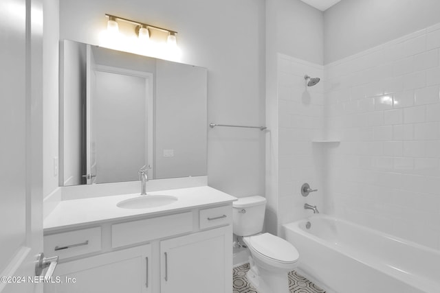 full bathroom featuring tile patterned floors, vanity, tiled shower / bath combo, and toilet