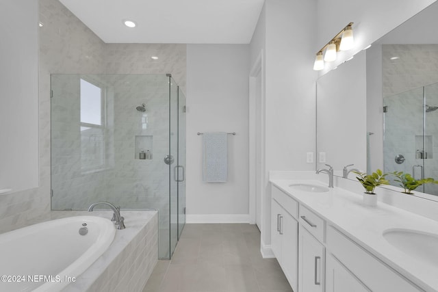 bathroom featuring plus walk in shower, vanity, and tile patterned flooring