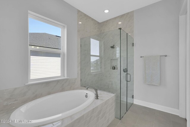 bathroom featuring tile patterned floors and shower with separate bathtub