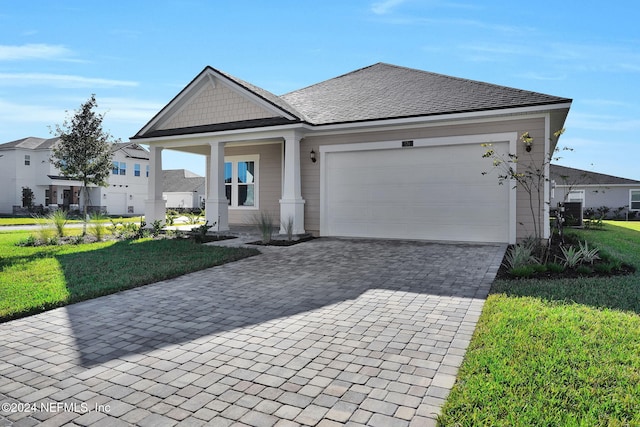 view of front facade with a front yard and a garage