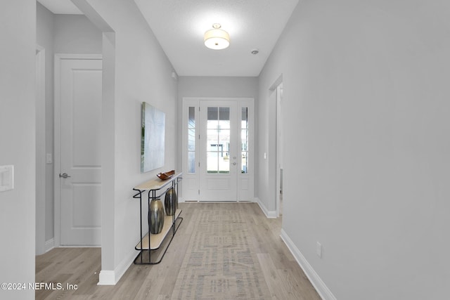 interior space featuring a textured ceiling and light hardwood / wood-style flooring