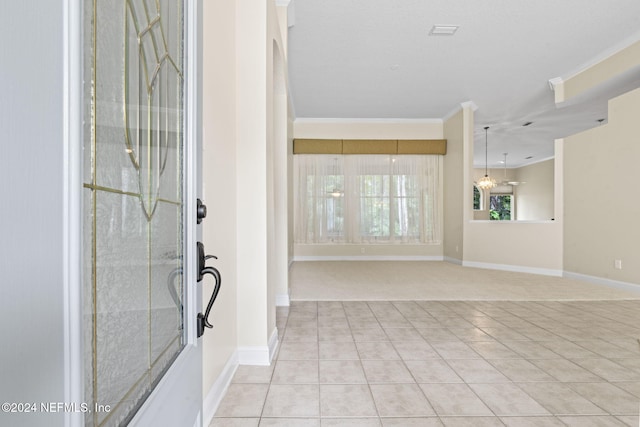 foyer featuring ornamental molding and light tile patterned flooring