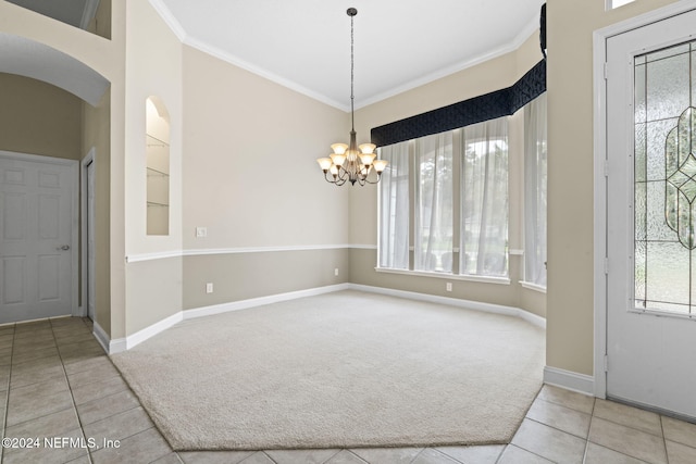 interior space with tile patterned floors, ornamental molding, and a notable chandelier