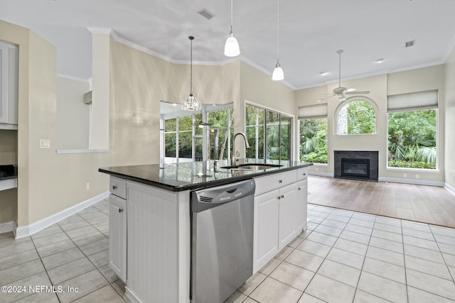 kitchen featuring light hardwood / wood-style floors, a center island with sink, white cabinetry, sink, and dishwasher