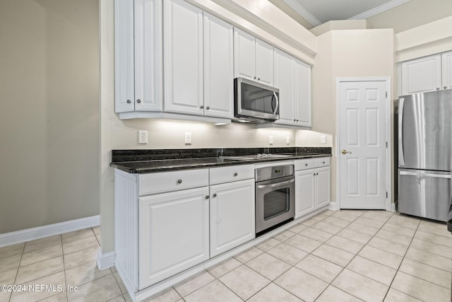 kitchen with white cabinetry, stainless steel appliances, light tile patterned flooring, and crown molding