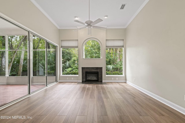 unfurnished living room featuring light hardwood / wood-style floors, ceiling fan, and crown molding