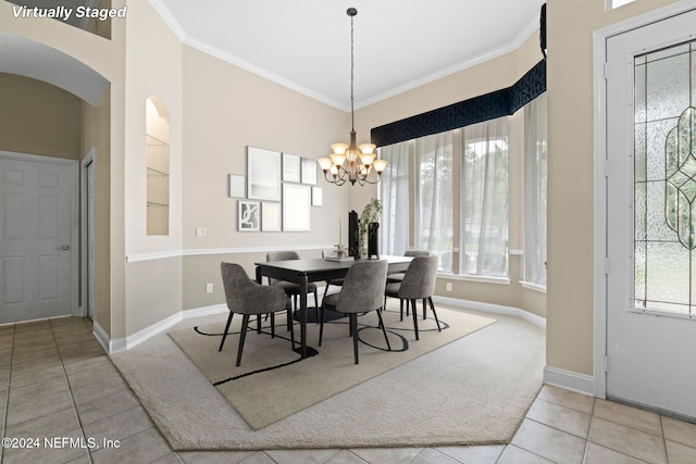 dining room featuring light tile patterned floors, ornamental molding, and plenty of natural light