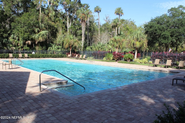 view of swimming pool featuring a patio area