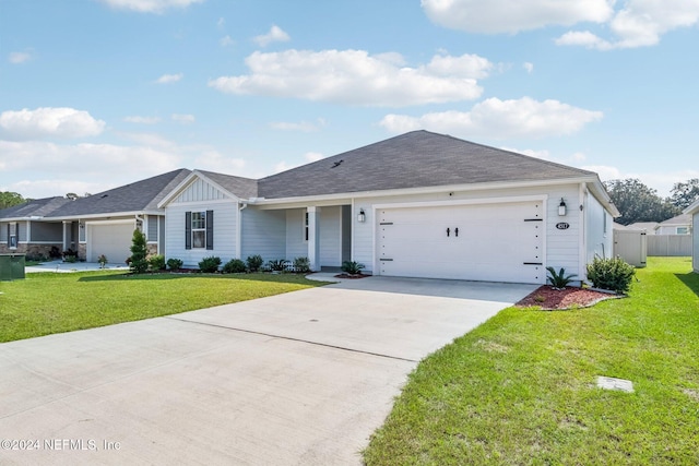 ranch-style home featuring a front lawn and a garage