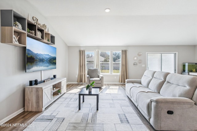 living room featuring vaulted ceiling and hardwood / wood-style flooring