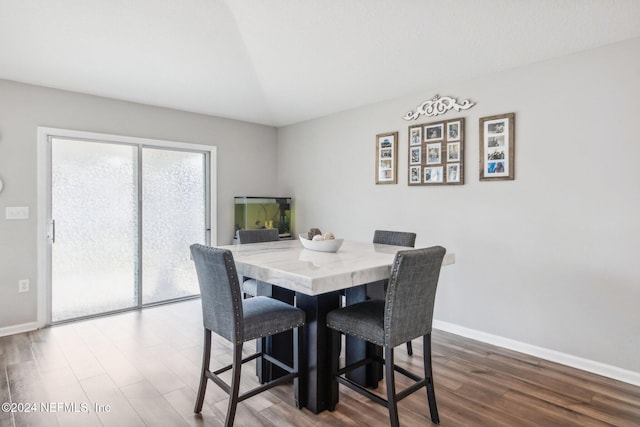 dining area with dark hardwood / wood-style floors