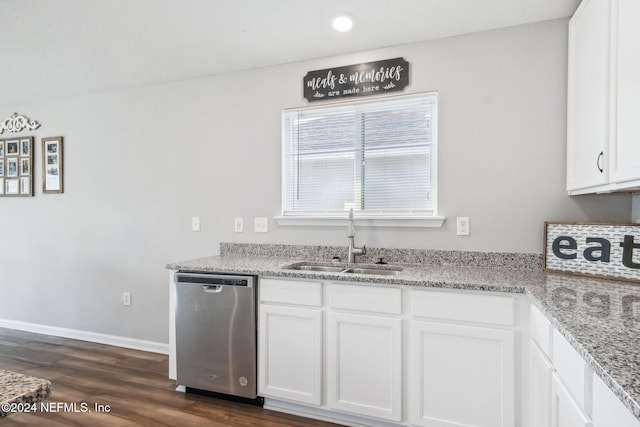 kitchen with light stone countertops, sink, stainless steel dishwasher, white cabinets, and dark wood-type flooring