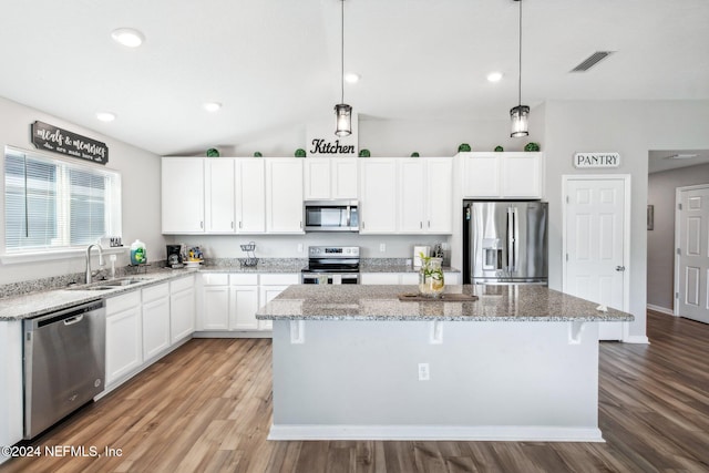 kitchen featuring sink, appliances with stainless steel finishes, pendant lighting, and light hardwood / wood-style floors