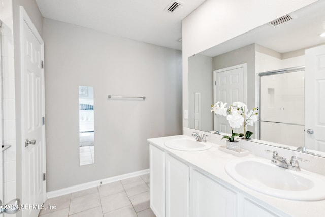 bathroom featuring vanity, tile patterned flooring, and an enclosed shower