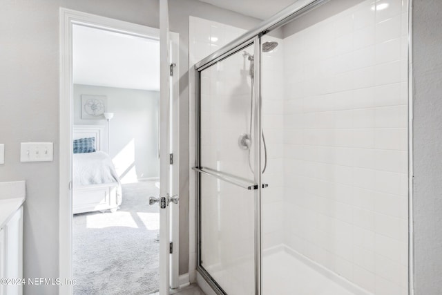 bathroom featuring vanity and an enclosed shower