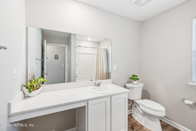 bathroom with vanity, hardwood / wood-style floors, a shower with curtain, and toilet