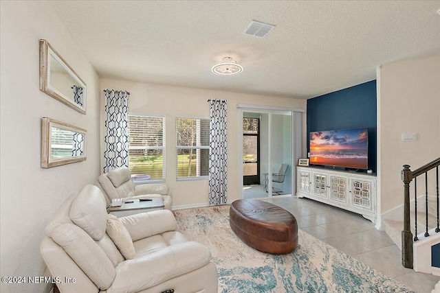 living room featuring a textured ceiling and tile patterned flooring