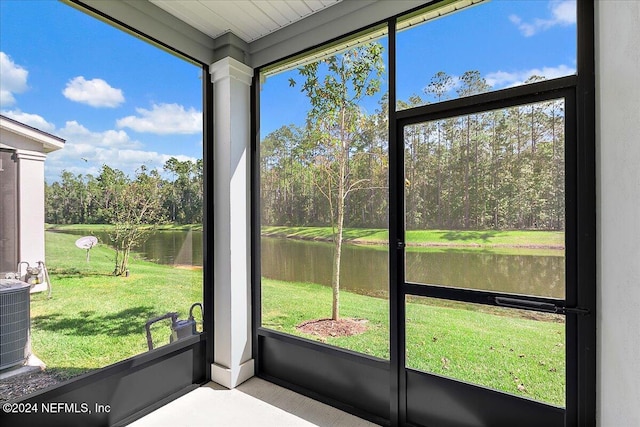 unfurnished sunroom with a healthy amount of sunlight and a water view